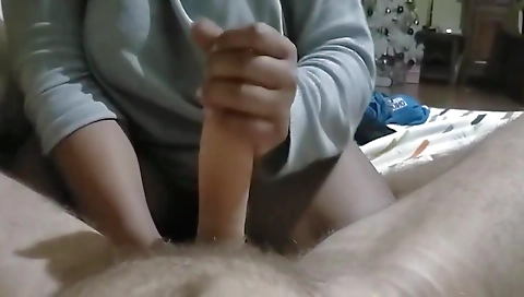 A black mature woman with a big cock gives a handjob