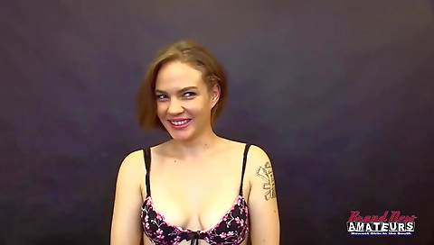 A blonde teen with blue eyes is showing her deep throat